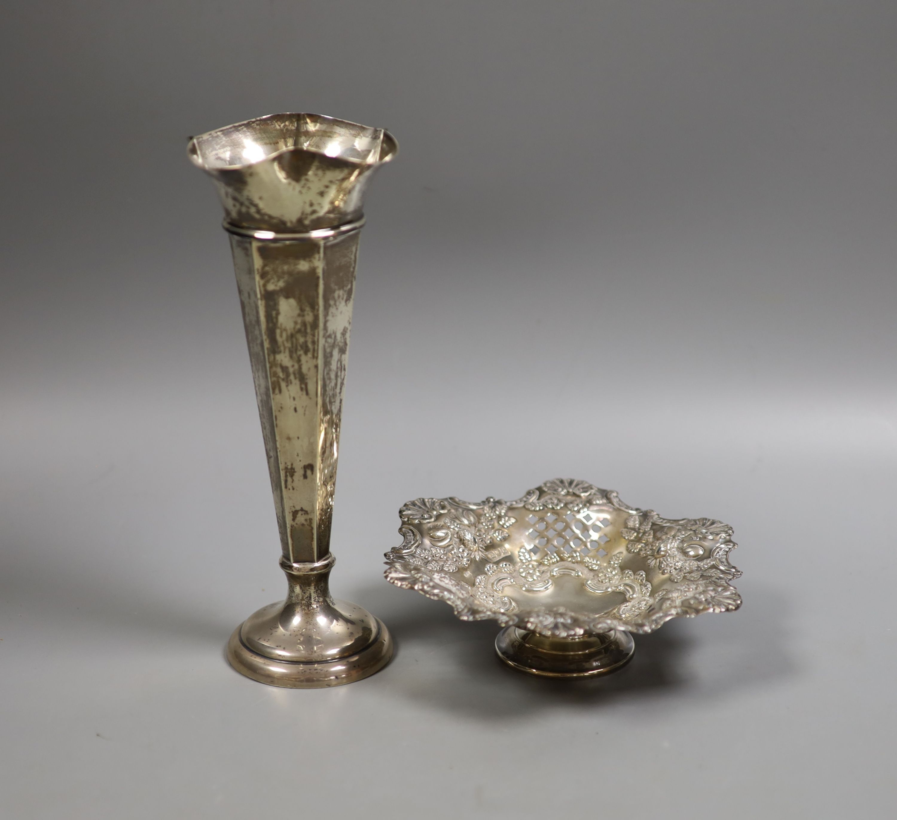 A late Victorian pierced silver pedestal bonbon dish, London, 1898, 16cm and a later silver mounted spill vase, 21.7cm, weighted.